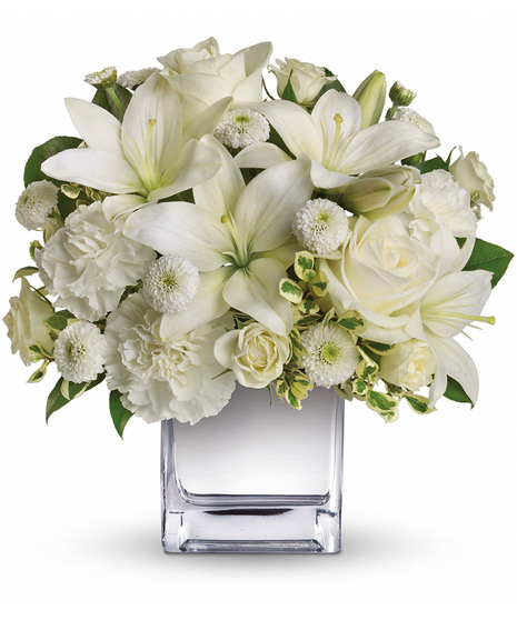 White roses, lilies and other favorites are displayed in a chic mirrored silver cube.