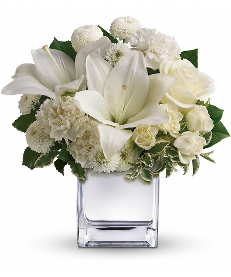 White roses, lilies and other favorites are displayed in a chic mirrored silver cube.