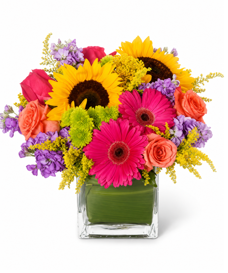 Bright and sunny sunflowers are arranged with coral roses and bright gerber daisies 