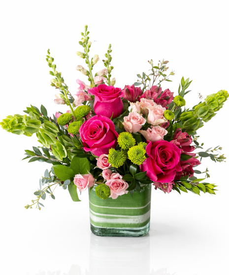 Stunning roses, delicate alstroemeria and dramatic snapdragons are hand-delivered in a classic cube vase lined with a green leaf